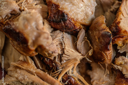 Closeup texture of roasted pork pieces with crispy edges.