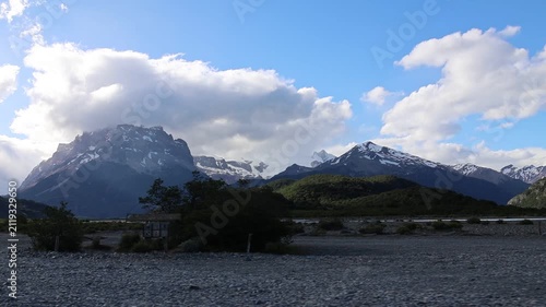 Beautiful snow-capped mountain landscapes in Los Glaciares National Park; the sky is clear with many clouds.