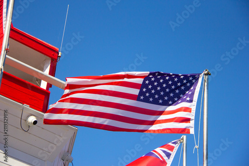 American flagflying next to a lighthouse