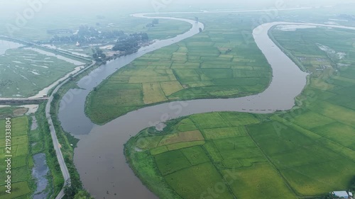 Beautiful Countryside River Flowing Through Green Crop Fields