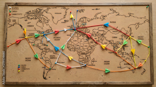 World map with colorful push pins and marked routes, travel plann