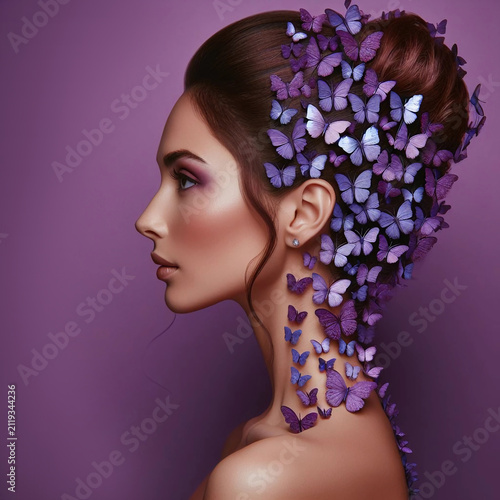 Portrait of a woman with butterflies in her hair.