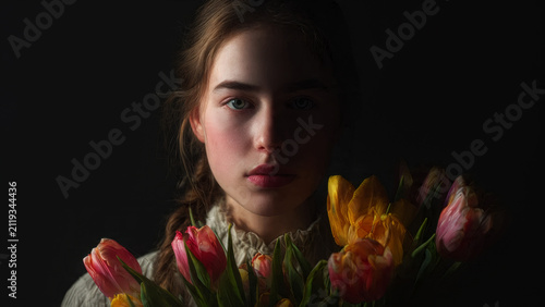 Woman with a bouquet of tulips.