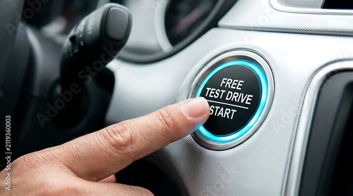 Hand pressing free test drive start button in car