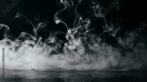 Dramatic swirling white smoke against a dark background creates an abstract atmospheric effect for moody conceptual designs and artistic expression