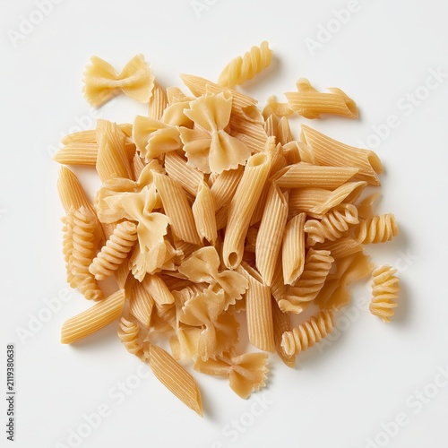 Dry Italian pasta sits on a white background.