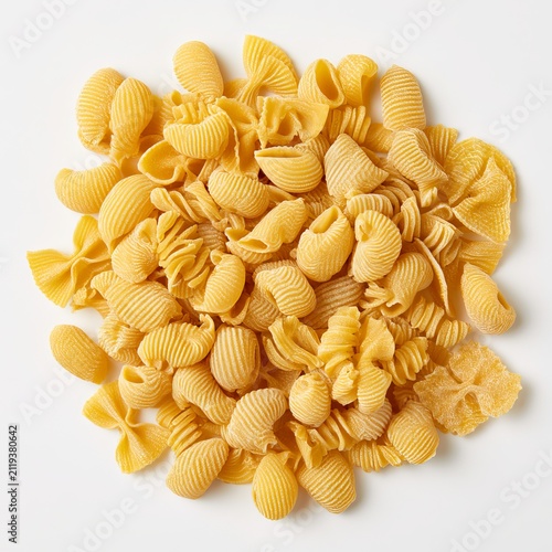 Dry Italian pasta sits on a white background.