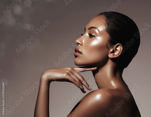 Elegant Woman with Radiant Glowing Skin and Slicked Back Hair Profile View