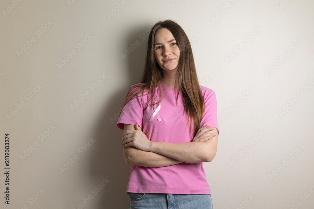 Obraz premium Young woman with pink ribbon raising breast cancer awareness