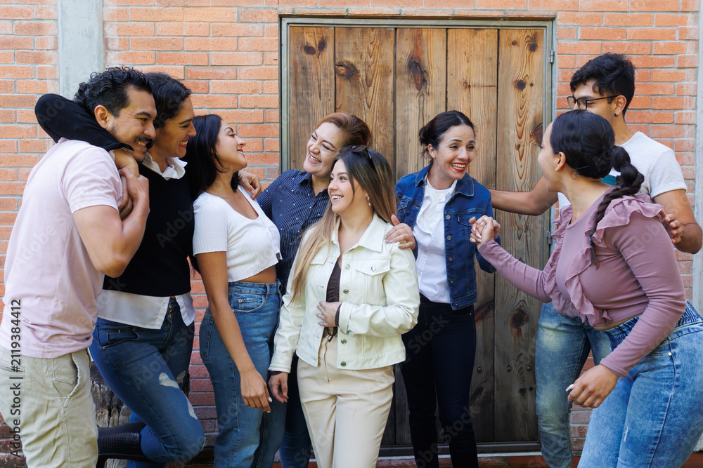 Fototapeta premium group of latin and multigenerational people or family together in a terrace outdoors in Mexico Latin america. Portrait of diverse hispanic group of friends