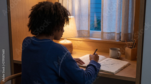 Teen journals by lamplight for a screen-free wind-down