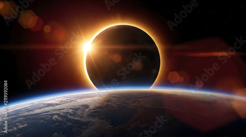 Stunning total solar eclipse viewed from orbit, showcasing moon eclipsing sun above planet earth.