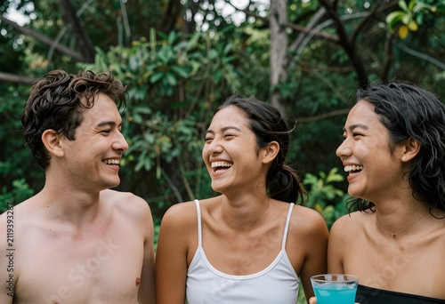 Three happy young adult fri...