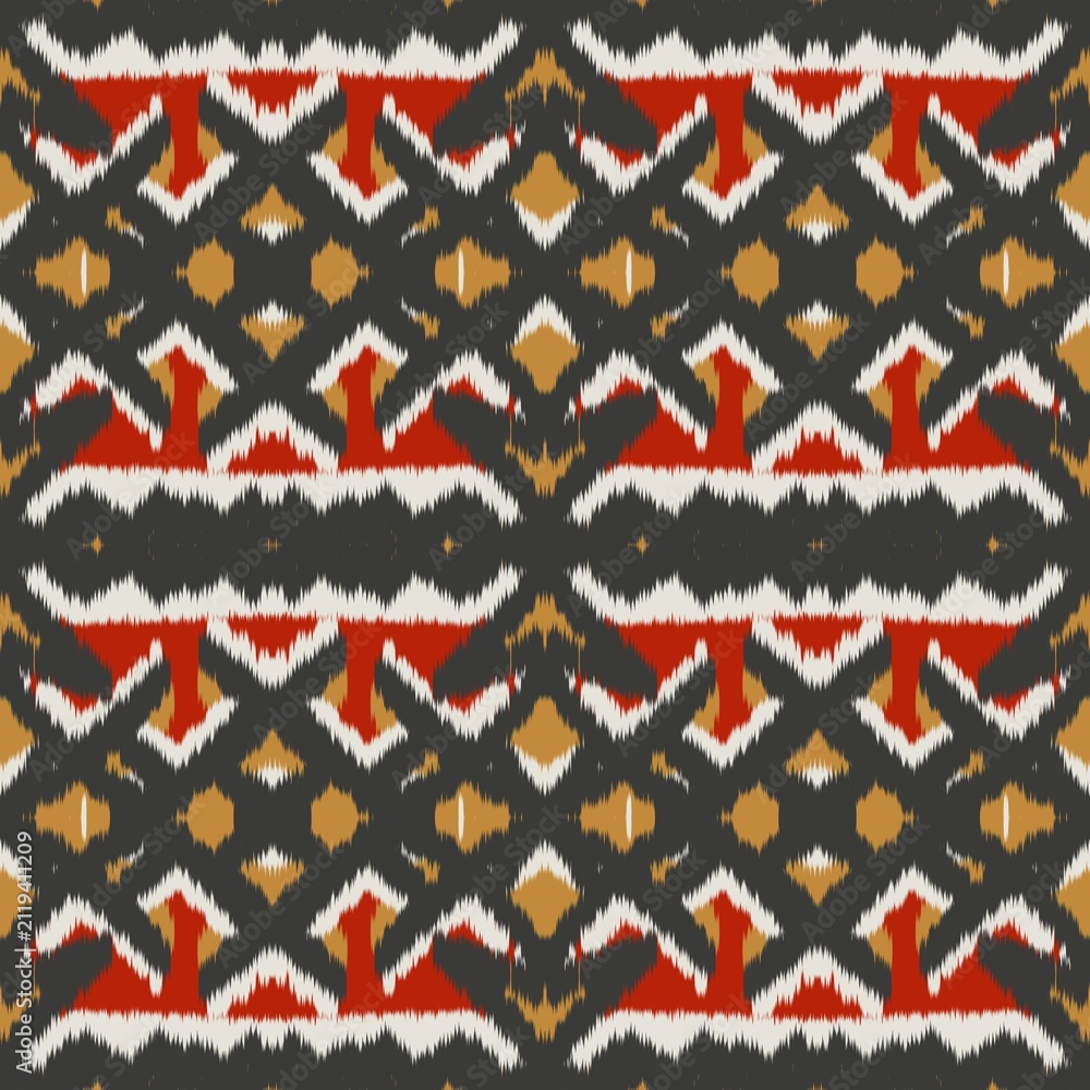 Fototapeta premium Seamless ethnic ikat pattern with bold red and gold geometric motifs on a dark grey background. Tribal fabric design perfect for bohemian prints, wallpaper, and creative decor.