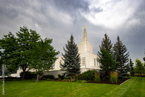 Beautiful exterior view of the Idaho Falls Idaho Temple of The Church of Jesus Christ of Latter-day Saints, featuring its distinctive white spire, elegant architecture, and peaceful grounds 