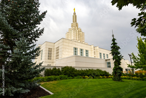 Beautiful exterior view of the Idaho Falls Idaho Temple of The Church of Jesus Christ of Latter-day Saints, featuring its distinctive white spire, elegant architecture, and peaceful grounds 