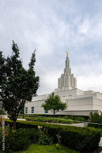 Beautiful exterior view of the Idaho Falls Idaho Temple of The Church of Jesus Christ of Latter-day Saints, featuring its distinctive white spire, elegant architecture, and peaceful grounds 