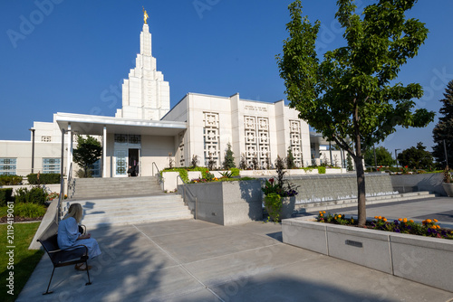 Beautiful exterior view of the Idaho Falls Idaho Temple of The Church of Jesus Christ of Latter-day Saints, featuring its distinctive white spire, elegant architecture, and peaceful grounds 