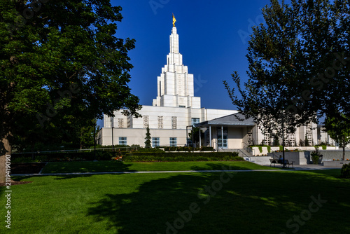 Beautiful exterior view of the Idaho Falls Idaho Temple of The Church of Jesus Christ of Latter-day Saints, featuring its distinctive white spire, elegant architecture, and peaceful grounds 