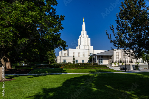 Beautiful exterior view of the Idaho Falls Idaho Temple of The Church of Jesus Christ of Latter-day Saints, featuring its distinctive white spire, elegant architecture, and peaceful grounds 