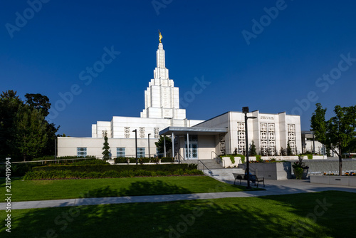 Beautiful exterior view of the Idaho Falls Idaho Temple of The Church of Jesus Christ of Latter-day Saints, featuring its distinctive white spire, elegant architecture, and peaceful grounds 