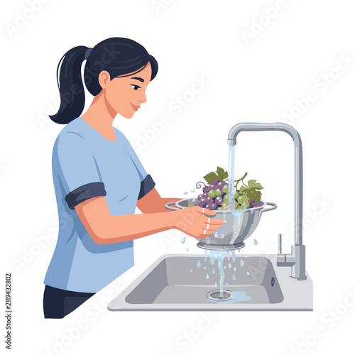 Washing grapes in a kitchen sink with water running from the faucet