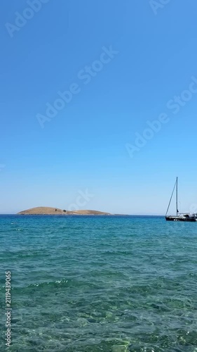 Palamutbükü Datça, crystal-clear turquoise sea, glass-like water, white sailboat, peaceful Mediterranean coast, cinematic summer view