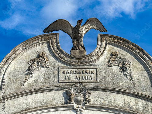 Foto Pilar, historic Carniceria El Aguila butcher shop facade with eagle sculpture -
