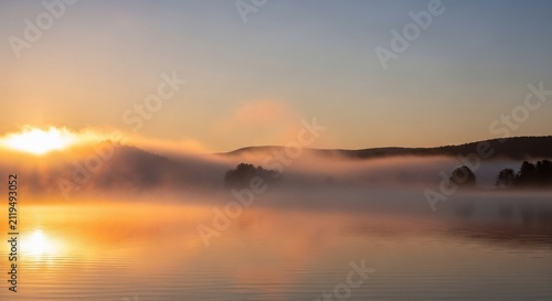 Sunrise over lake with fog