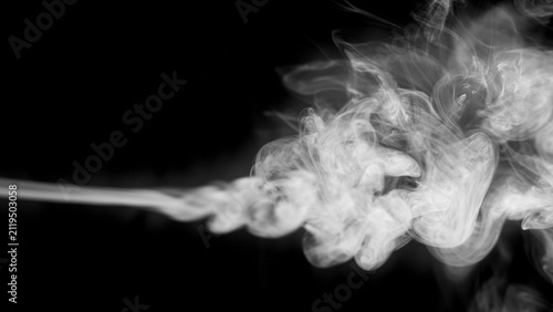 Принти на полотні A dense plume of white smoke streams from the left of the frame, expanding into complex, swirling patterns and delicate wisps against a pure black background