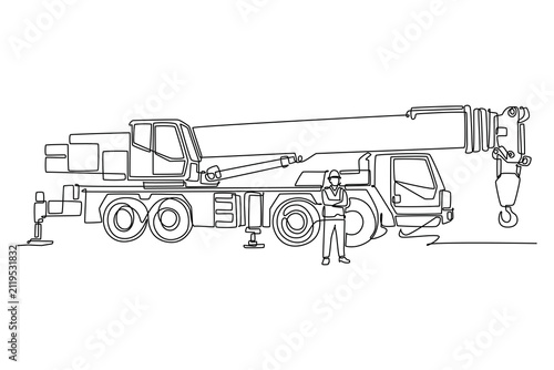 Single continuous line drawing young male engineer wearing a hardhat and safety vest standing with arms folded in front of a giant mobile crane truck. One line draw graphic design vector illustration