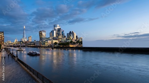 Modern city skyline and river at twilight
