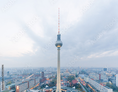 Bild auf Leinwand TV Tower rising above the city skyline under dramatic cloudy skies in Berlin, Ge