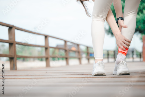 Fotografía Woman suffers Achilles tendon ankle injury holding foot during workout, female a
