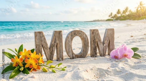 Large wooden letters spelling mom on a sandy beach with turquoise ocean waves and a bouquet of yellow orchids and pink flowers in the corner