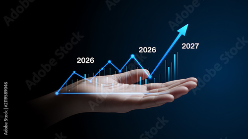 Person's hand presenting a luminous blue financial growth chart with bars and line graph for 2026