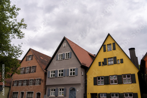 Row of colorful historic houses under a cloudy sky.