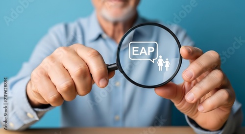 Senior businessman holding magnifying glass focused on employee assistance program concept