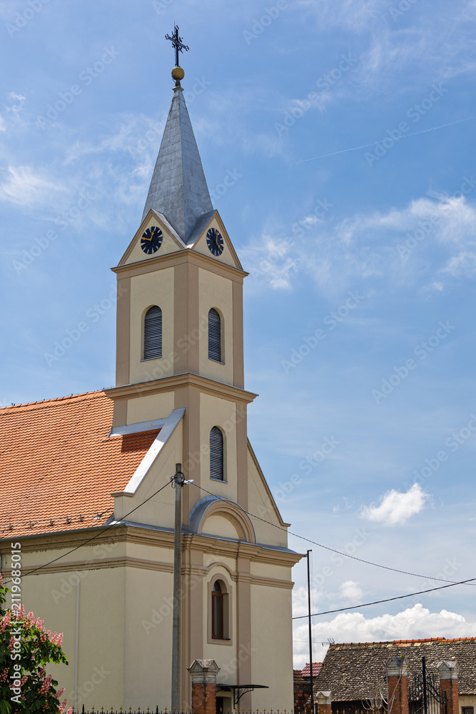 Fototapeta premium Historic Village Church Steeple With Clock Tower, church of St. Andrew the Apostle in Andrijasevci, Croatia
