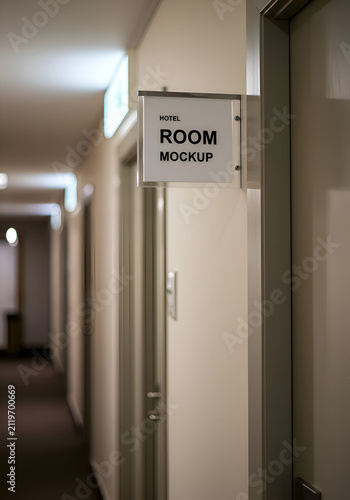 Hotel room mockup sign on beige hallway wall. Neutral, professional sign displays a hotel room mockup. Business, hotel, or hospitality use.