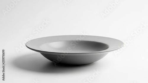 Empty gray ceramic soup bowl on a plain white surface