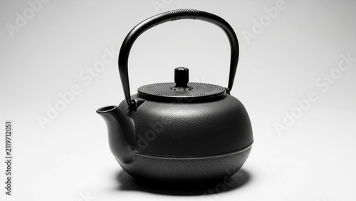 Traditional black cast iron teapot on a white background