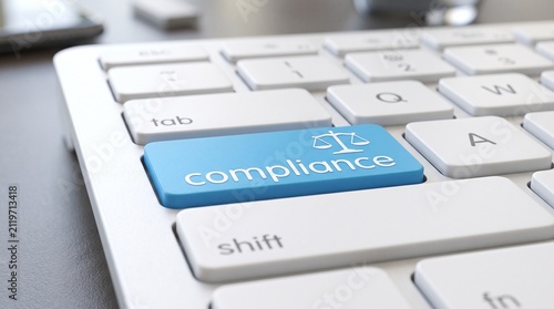 Compliance Key on Keyboard: A close-up view of a modern keyboard highlights a prominent blue key labeled compliance, featuring an icon of scales of justice.