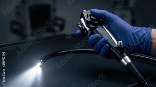 Close-up of a Medical Professional Holding a Laparoscopic Endoscope Tool with Bright Light for Diagnostic Procedures