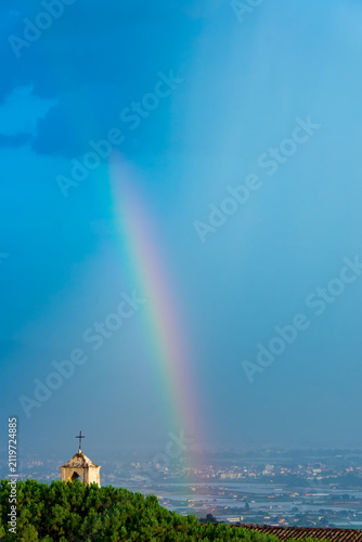 View of the vertical small rainbow in the hill