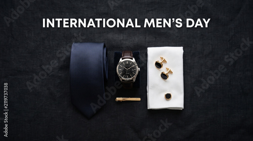 Elegant menswear accessories featuring dark blue necktie wristwatch gold cufflinks with accessories including textured neatly arranged collection displays neatly