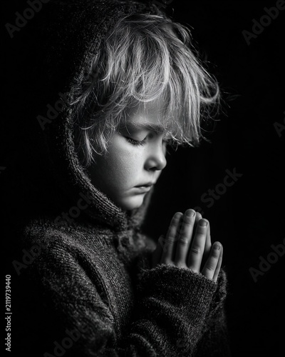 Child praying in peaceful spiritual moment with soft light atmosphere. Ai Generative