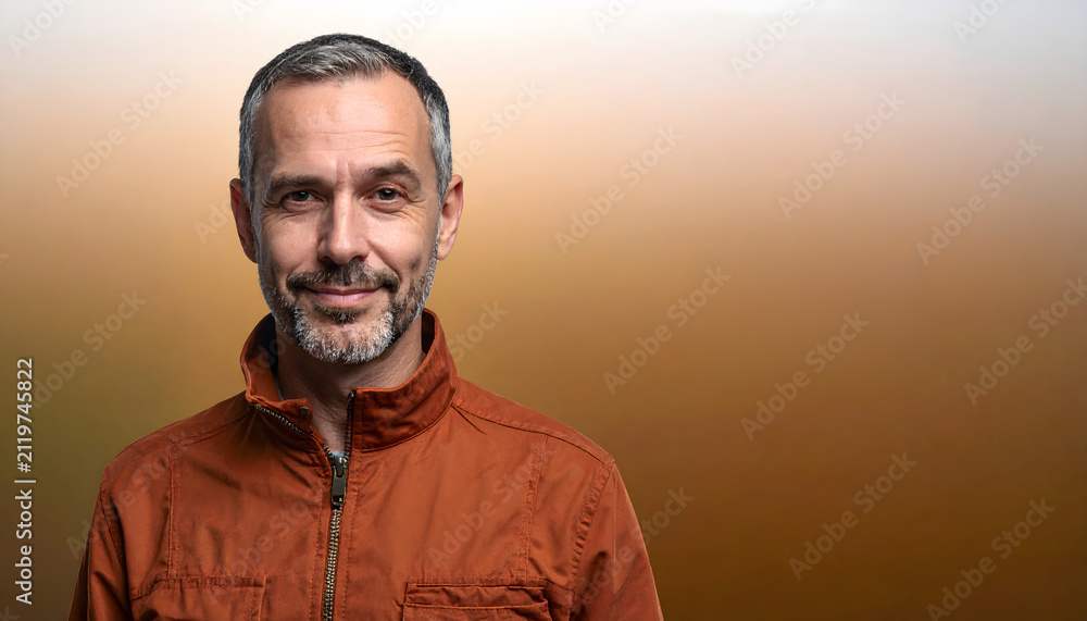Fototapeta premium Mature man stands looking cheeky wearing rust colored jacket for casual dining brand advertising generative AI