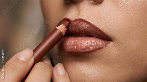 Macro lip liner application close up | Professional makeup tutorial beauty photography | Brown lip pencil on full lips editorial | Skin texture and lip makeup macro shot