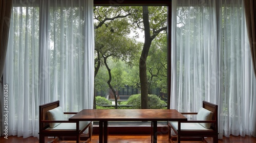 Interior view with window revealing a peaceful green landscape and seating